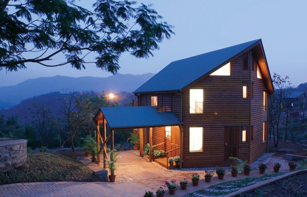 Aamby Valley City Lonavala Exterior photo A log cabin in the resort